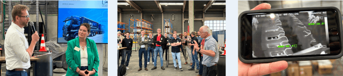 Warehouse area with shelves, woman in green blazer operating machines, factory building in the background.