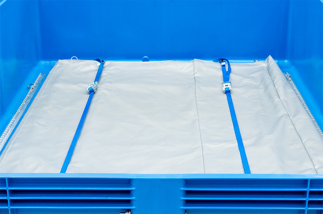 A blue plastic box with a grey tarpaulin base and blue straps.